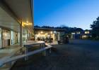 Exterior view of covered courtyard at dusk at Hone Heke Lodge backpackers Kerikeri