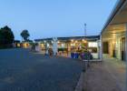 Exterior view of covered courtyard at dusk at Hone Heke Lodge backpackers Kerikeri