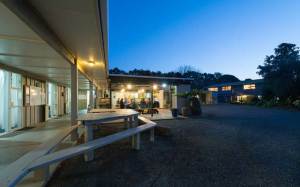 Exterior view of covered courtyard at dusk at Hone Heke Lodge backpackers Kerikeri